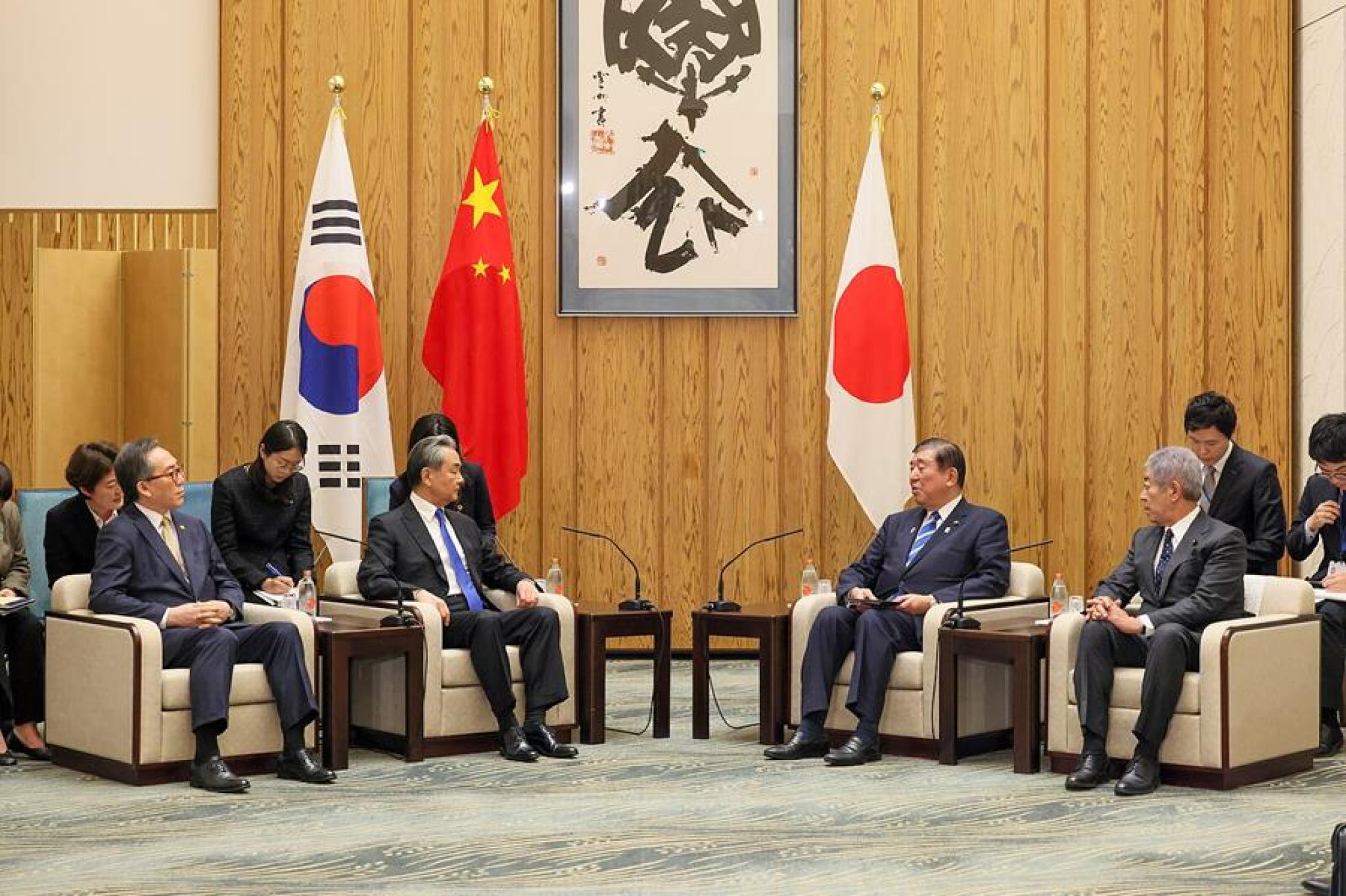 Chinese Foreign Minister Wang Yi, Japanese Foreign Minister Takeshi Iwaya, and South Korean Foreign Minister Cho Tae-yul meet in Tokyo during the 11th Trilateral Foreign Ministers’ Meeting on 22 March 2025.