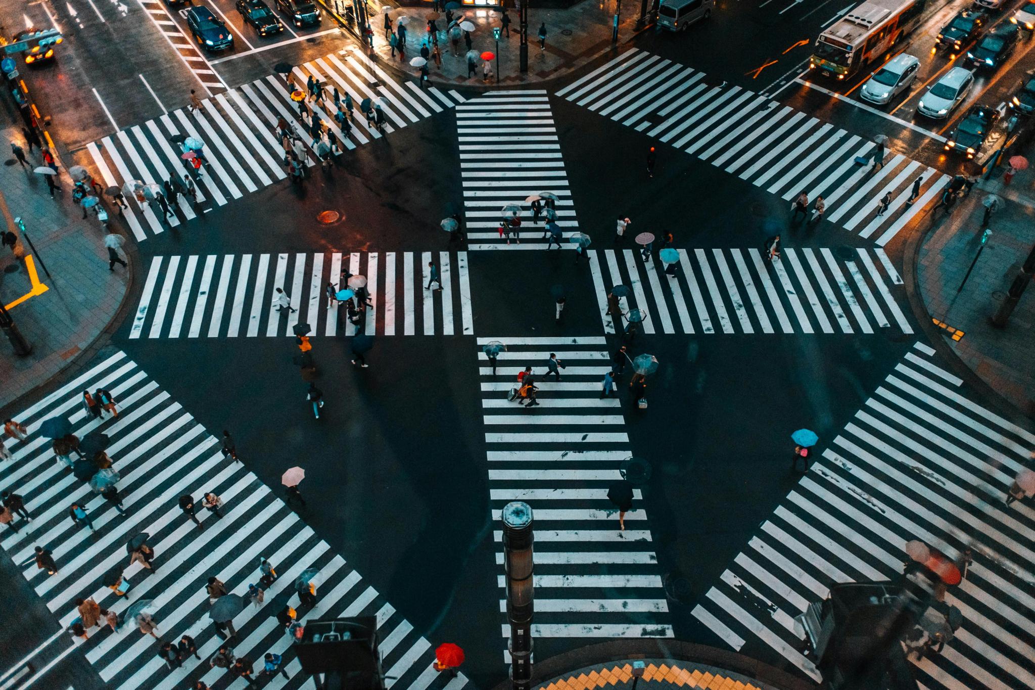A bustling aerial view of Shibuya Crossing, Tokyo with pedestrians and umbrellas, Tokyo, Japan, 21 February 2021 (Photo: Hafeisi/Pexels).