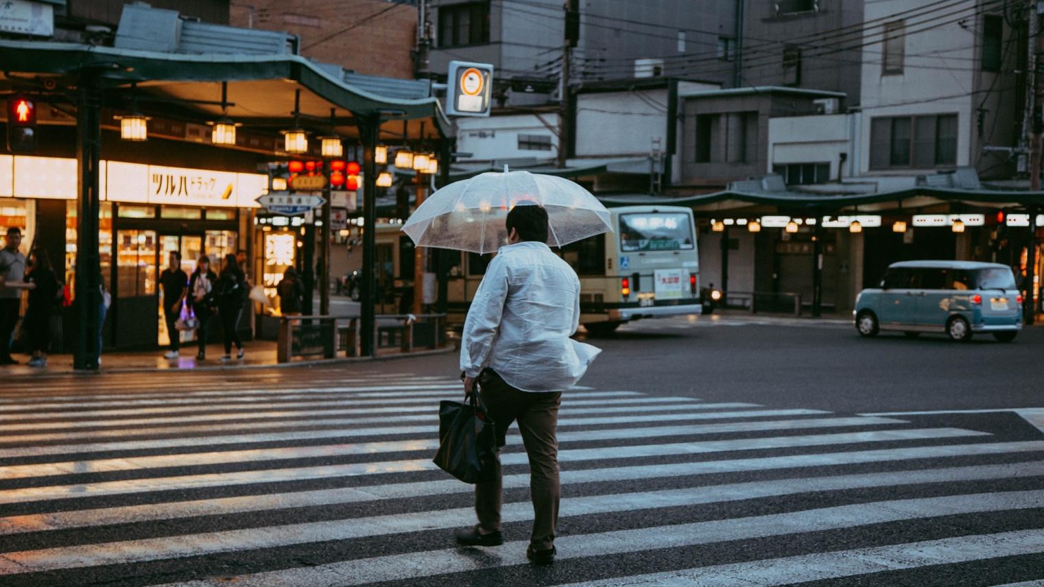Walking man with an umbrella in Japan