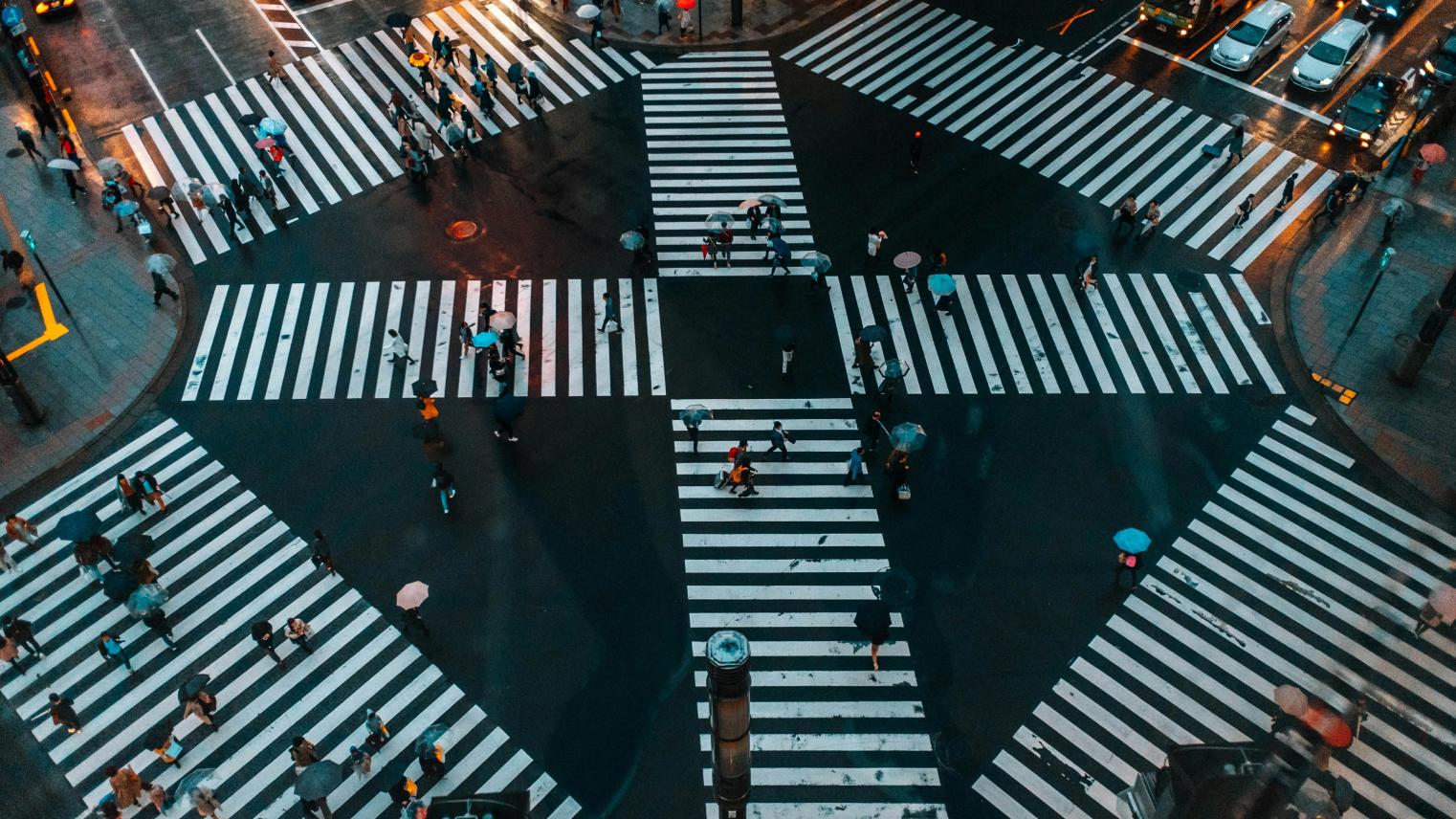 A bustling aerial view of Shibuya Crossing, Tokyo with pedestrians and umbrellas, Tokyo, Japan, 21 February 2021 (Photo: Hafeisi/Pexels).