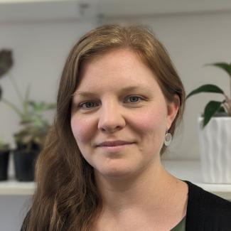 Meg Arthur smiling in front of plants